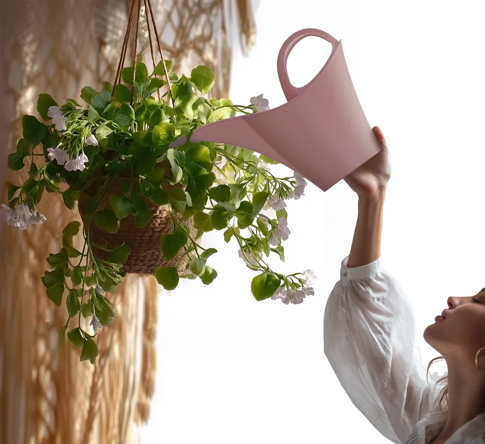 A hanging basket watered from above with a KEIRA can